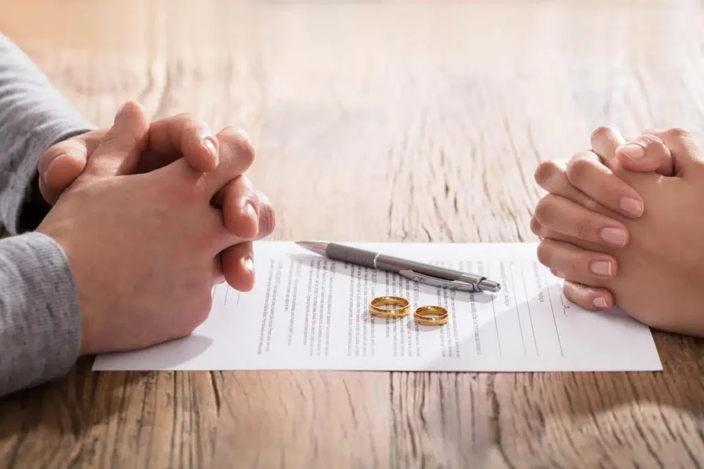 A separation agreement on a desk between two people: the work of a no-fault divorce file.